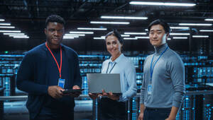 Diverse Team of Data Center System Administrators and IT Specialists Use Laptop and Tablet Computers, Smiling on Camera. IT Engineers work on Cyber Security Protection in Cloud Computing Server Farm.